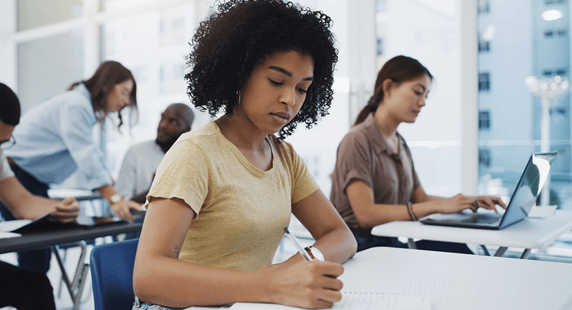 a female student takes a test in the classrom